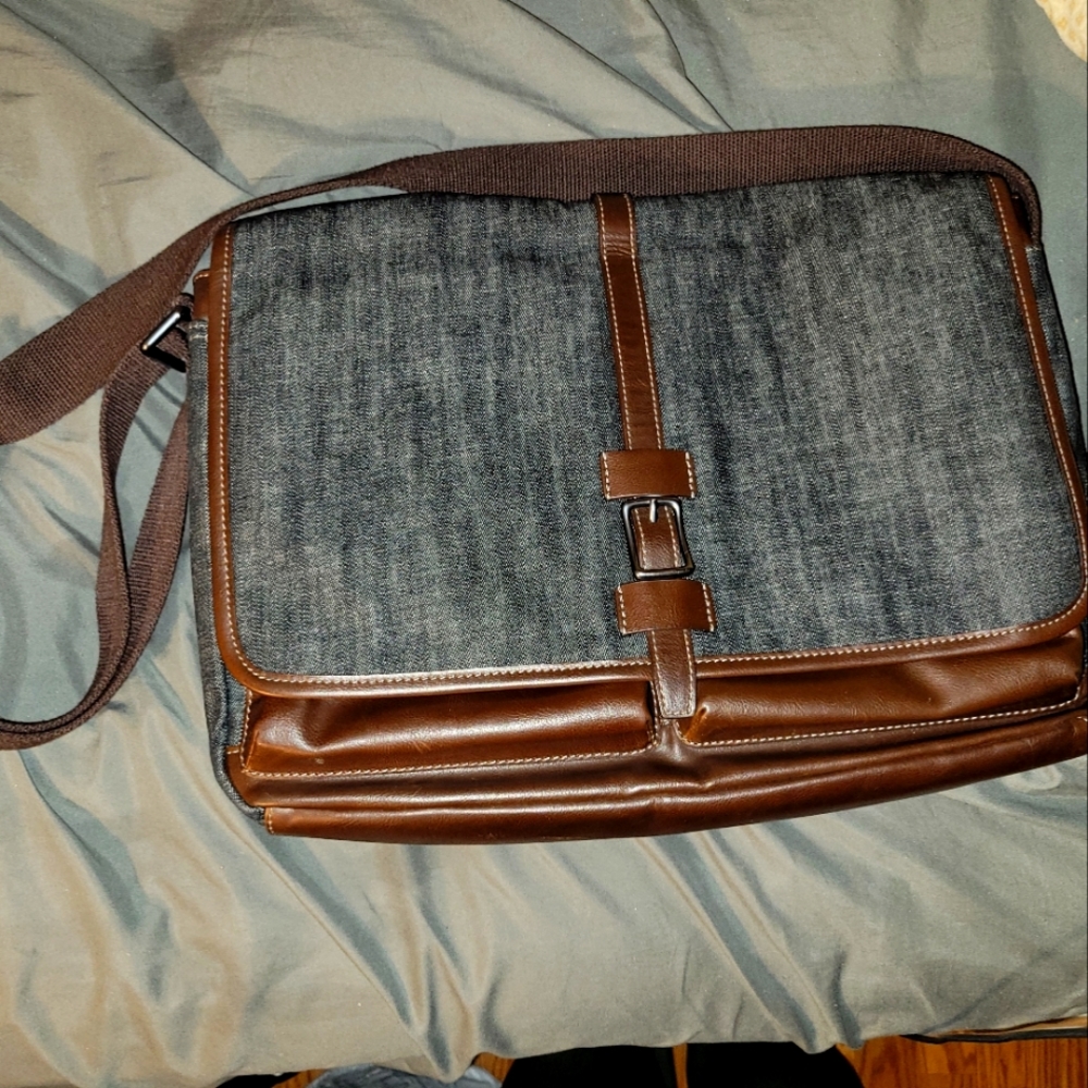 Fossil dark wash denim with coffee brown leather accents.